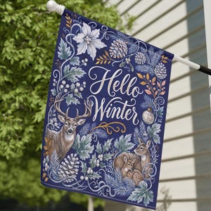 May include: A rectangular navy blue garden flag featuring the white text Hello Winter in the center. The design includes illustrations of a buck, a doe, and a fawn surrounded by white poinsettias, pinecones, pine branches, and berries.