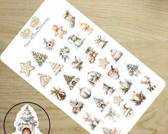May include: A white sticker sheet featuring various watercolor Christmas illustrations including gingerbread men, snowmen, reindeer, pine trees, bells, and gifts. The text Twice As Nice Lettering is printed in the corner. A circular inset shows a fireplace.