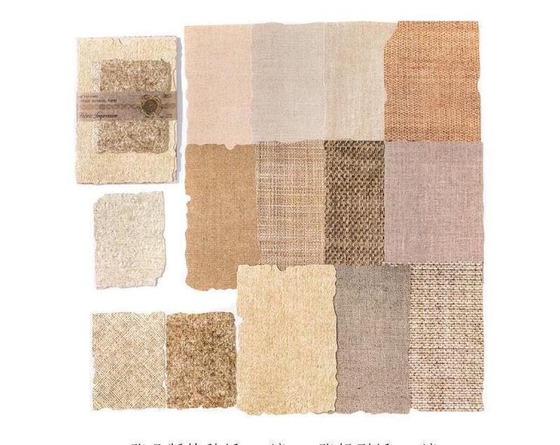 May include: A collection of various textured paper and fabric swatches in neutral tones. The samples include shades of beige, brown, and cream, with visible textures like woven patterns and rough edges. Some swatches are layered and bound with a label.