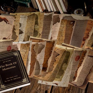 May include: A collection of aged paper sheets with handwritten script and torn edges, arranged on a wooden surface. Some sheets have a red wax seal. A book titled "The Book Of Memories" is also present.