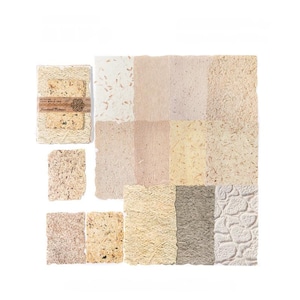 May include: A collection of handmade paper sheets in various shades of beige, cream, and brown. The paper has a textured, organic appearance, with visible fibers and inclusions. Some sheets are bundled with a decorative band.