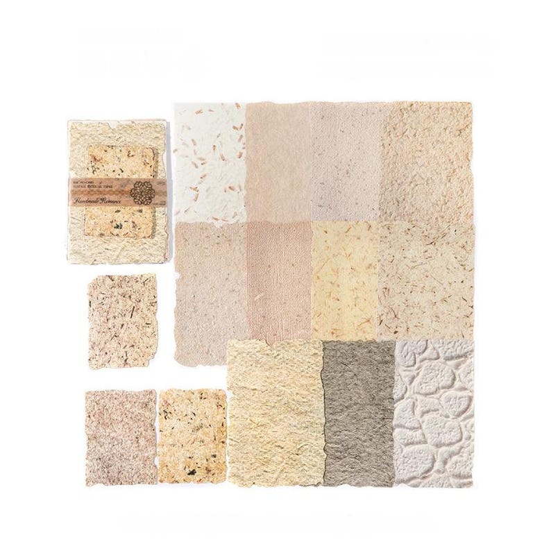 May include: A collection of handmade paper sheets in various shades of beige, cream, and brown. The paper has a textured, organic appearance, with visible fibers and inclusions. Some sheets are bundled with a decorative band.