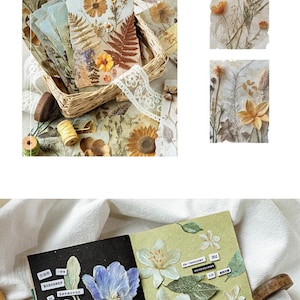 May include: A collection of decorative paper sheets featuring pressed flower and botanical illustrations in warm earth tones and cool blue hues. The set includes rectangular cards with floral arrangements, a notebook with blue and white flower stickers, and text labels.