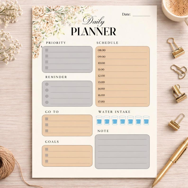 May include: A beige daily planner with floral accents and the words "Daily Planner" at the top. It includes sections for priority, schedule, reminders, goals, and water intake. Gold binder clips and a pen are on the side.