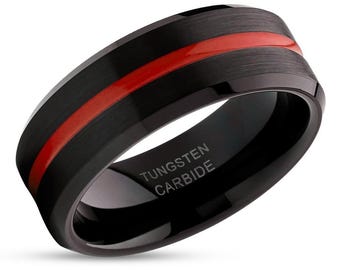 May include: Black tungsten carbide ring with a red stripe and the words "TUNGSTEN CARBIDE" engraved on the inside.