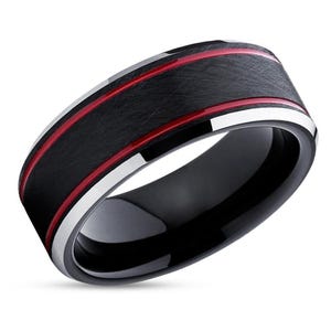 May include: A black tungsten carbide ring with a brushed finish and two red lines around the band.