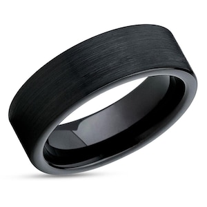 May include: A black brushed tungsten ring with a polished edge.