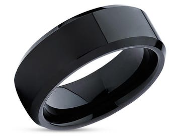 May include: A black ceramic ring with a beveled edge.