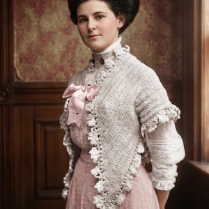 May include: A vintage portrait of a woman in a light pink dress and a white crocheted shawl. The shawl has a scalloped edge and is adorned with a pink bow. The woman has dark hair and is posed in front of a patterned wall.