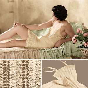 May include: A light yellow knitted slip dress with spaghetti straps. The dress has a delicate openwork design and is worn by a person lying on a bed. The bed has a green satin cover and a floral arrangement is nearby.