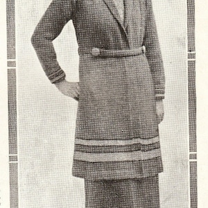 May include: A vintage-style ensemble featuring a long-sleeved coat with a matching skirt and hat. The coat has a belt and decorative trim. The skirt has horizontal stripes near the hem. The outfit is in shades of gray and brown, with a patterned hat.