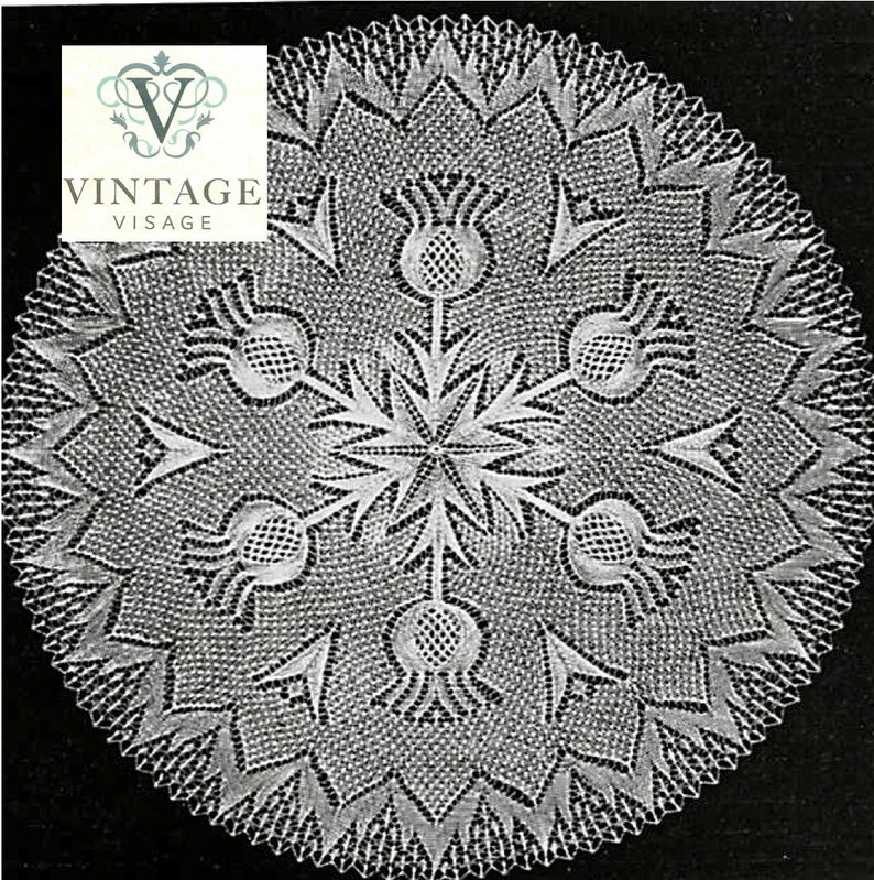 May include: A white, circular doily with a detailed floral pattern. The design includes a central starburst and thistle-like elements. The edges are scalloped. The doily has a vintage aesthetic, with the 'Vintage Visage' logo in the top left corner.