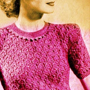 May include: A vintage-style image of a woman wearing a pink knitted sweater. The sweater has a textured pattern and short sleeves. The woman has blonde hair and is looking to the side.