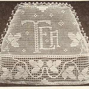 May include: A detailed, off-white crochet piece with a rectangular shape. The design features intricate patterns, including floral and geometric motifs. The edges are finished with a decorative trim, showcasing the craftsmanship.