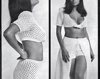 May include: A two-piece white crochet outfit. The top is a short-sleeved crop top. The bottom is a skirt with a slit. The outfit is made of a open weave crochet pattern.