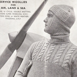 May include: Vintage advertisement featuring a man wearing a gray knitted wool hat and sweater. The hat has ear flaps and a button detail. The sweater has a cable knit design. Text reads "SERVICE WOOLLIES FOR AIR, LAND & SEA".