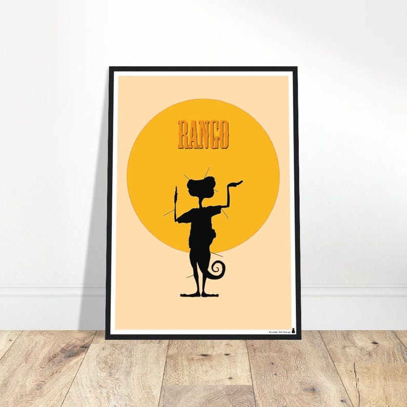 May include: A framed poster featuring a black silhouette of a creature with a curled tail, set against a yellow sun. The word "RANGO" is printed in orange above the creature. The background is a light peach color.