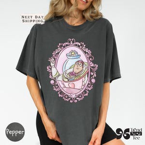 a woman wearing a t - shirt with a cartoon character on it