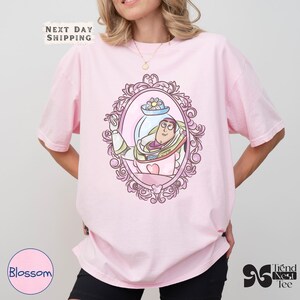 a woman wearing a pink shirt with a cartoon character on it