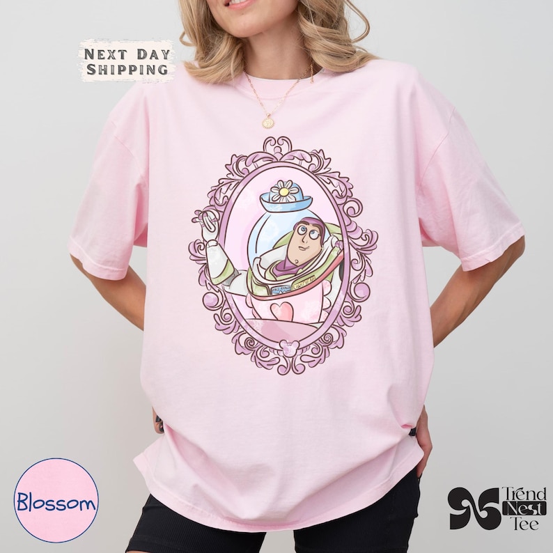 a woman wearing a pink shirt with a cartoon character on it