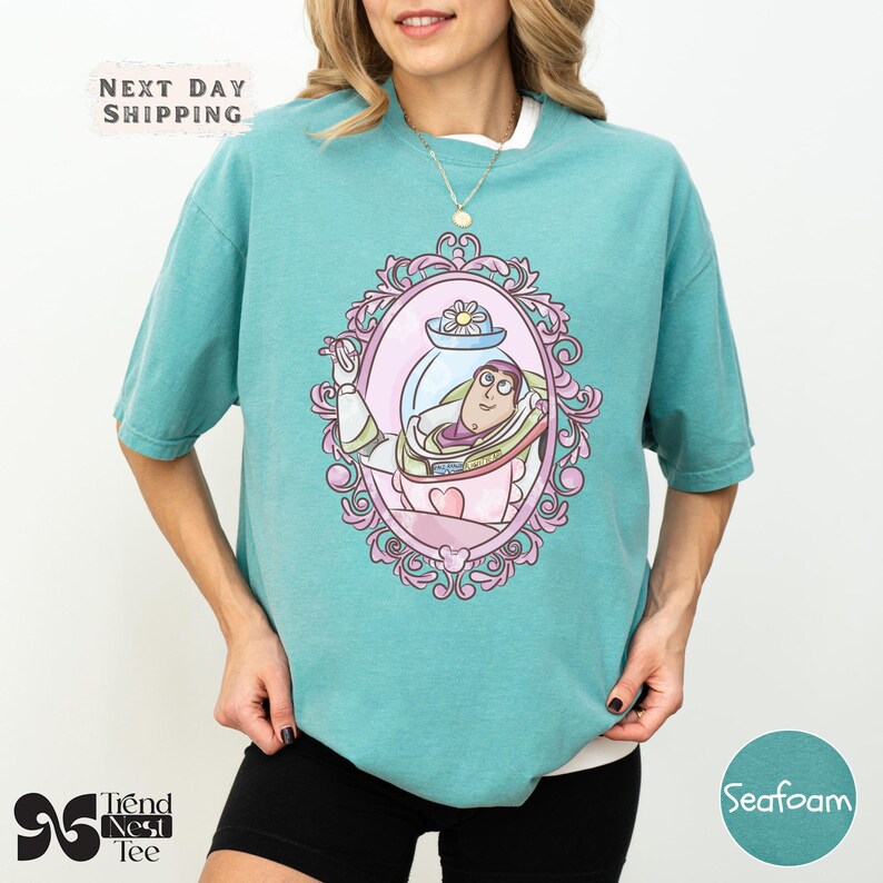 a woman wearing a green shirt with a picture of a mermaid on it