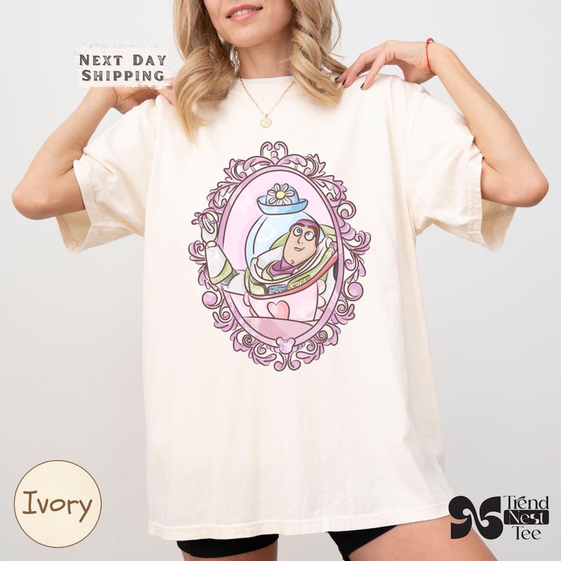 a woman wearing a white t - shirt with a picture of a princess on it