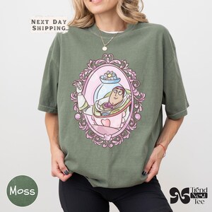 a woman wearing a green t - shirt with a picture of a woman in a