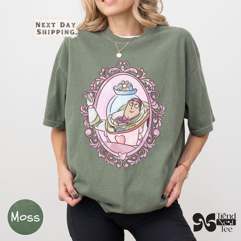 a woman wearing a green t - shirt with a picture of a woman in a