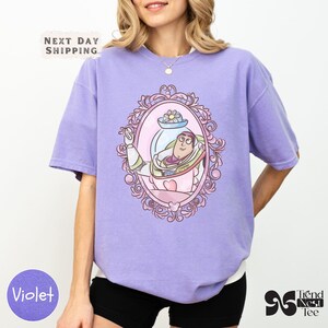 a woman wearing a purple shirt and black shorts