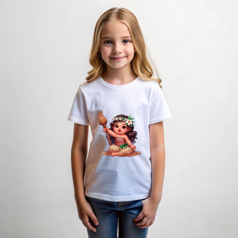 May include: White t-shirt with a cartoon image of a young girl wearing a flower crown and holding a wooden stick. The girl is wearing a brown and green skirt and is sitting on a pile of brown grass.