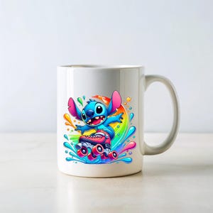May include: White ceramic mug with a colourful design featuring a blue cartoon character on roller skates. The character is surrounded by rainbow-coloured paint splatters.