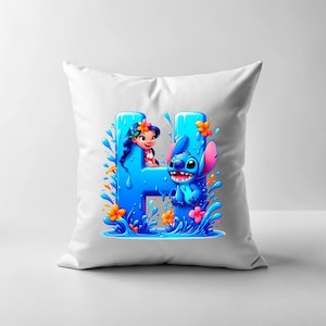 May include: White pillow with a blue and orange graphic of Stitch and Lilo from Disney's Lilo & Stitch. The graphic shows Stitch and Lilo in a pool of water with the letter H in the background.