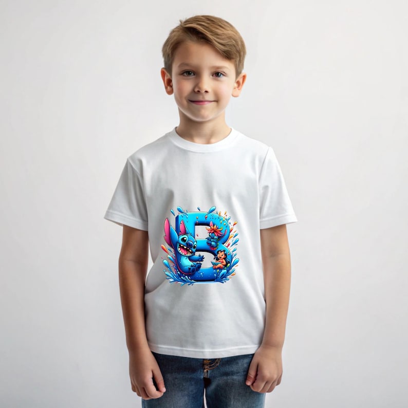 May include: White t-shirt with a blue Stitch character from Lilo & Stitch, holding a flower and standing in front of a blue letter B with water splashes.