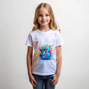 May include: White t-shirt with a blue Stitch character from Lilo & Stitch holding a blue number 3. The number is surrounded by colorful paint splatters.