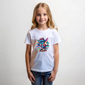 May include: A white t-shirt featuring a colourful graphic of a blue cartoon character skateboarding. The character is wearing a red jacket and a hat. The background is a colourful abstract design.