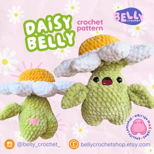 May include: Two crochet daisy plushies with yellow centers, white petals, and green bodies. One has a pink heart. The text "DAISY BELLY crochet pattern" is displayed in green. The Etsy shop name is "bellycrochetshop.etsy.com".