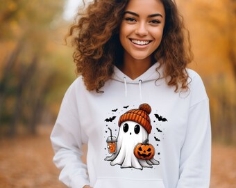 May include: White hoodie with a graphic of a ghost wearing a beanie and holding a pumpkin and a cup of coffee. The ghost is surrounded by bats.