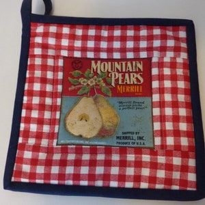 May include: Red and white checkered pot holder with a blue border. The center features a vintage label for "Mountain Pears Merrill" with a picture of pears and the text "Merrill Brand always picks a perfect pear!"  Shipped by Merrill, Inc. Produce of U.S.A.