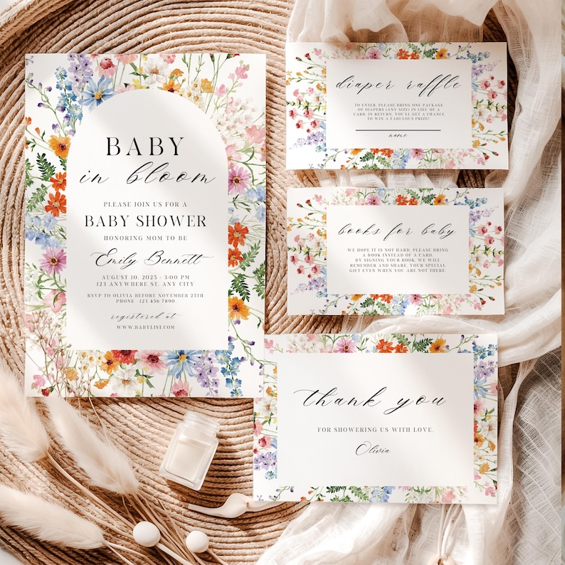 May include: A set of baby shower stationery with a floral design. The invitation features the text "Baby in Bloom" and event details. Additional cards include "Diaper Raffle," "Books for Baby," and a thank you note. The stationery is decorated with colorful flowers.