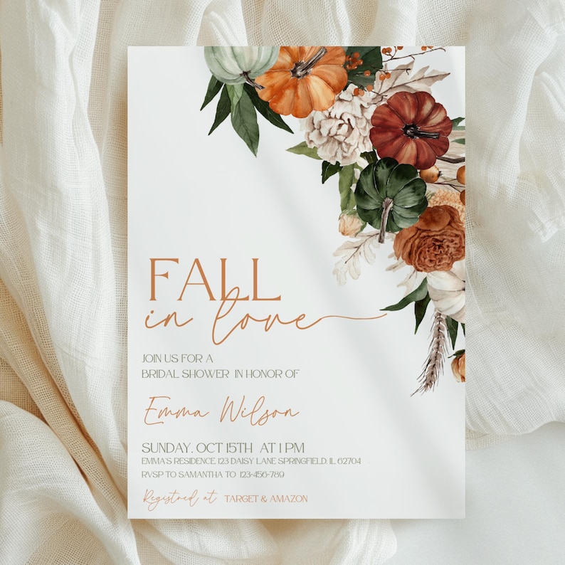 May include: A white invitation card with the text "FALL in love" in a copper color. The card is decorated with watercolor pumpkins, flowers, and greenery. The invitation is for a bridal shower honoring Emma Wilson.