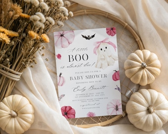 May include: A rectangular baby shower invitation card featuring a white ghost with a pink bow, black bats, and pink pumpkins. The text reads: A little BOO is almost due! PLEASE JOIN US FOR A BABY SHOWER HONORING MOM TO BE Emily Bennett OCTOBER 10, 2023 3:00 PM 123 ANYWHERE ST. ANY CITY RSVP TO OLIVIA BEFORE NOVEMBER 25TH PHONE 123 456 7890 REGISTERED AT WWW.BABYLIST.COM