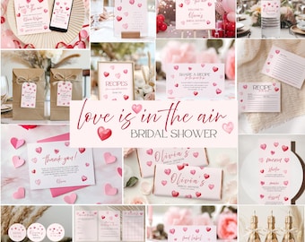 May include: A collection of pink and red heart-themed bridal shower decorations. Includes signs, cards, cupcake toppers, and champagne bottles. The text "love is in the air" and "Olivia's Bridal Shower" are visible on several items. The overall theme is romantic and celebratory.