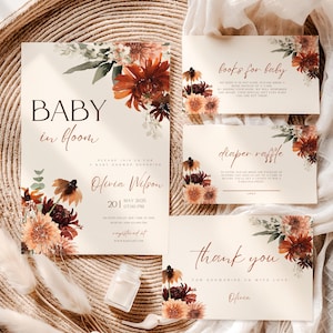 Puede incluir: Un conjunto de papelería para baby shower con fondo crema e ilustraciones florales en tonos óxido, naranja y rojo oscuro. Las tarjetas incluyen textos como Baby in bloom, Olivia Wilson, books for baby, diaper raffle y thank you con flores.
