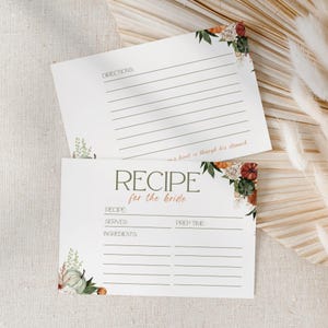 May include: Two white recipe cards with fall-themed floral accents. The top card reads "Directions" and includes lines for writing. The bottom card says "Recipe for the bride" with spaces for recipe details.