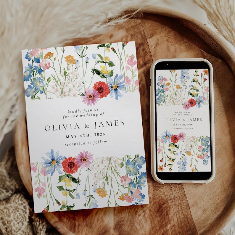 May include: A wedding invitation and a smartphone displaying the same design. The invitation and phone screen feature a floral border with colorful flowers and the text "OLIVIA & JAMES MAY 4TH, 2026 reception to follow."