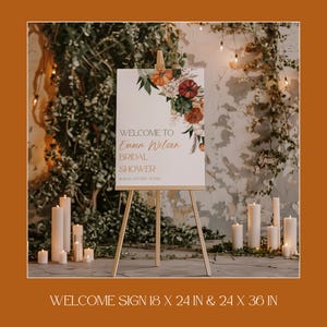 May include: A white welcome sign on a wooden easel, with floral and pumpkin accents. The sign reads "WELCOME TO Emma Wilson BRIDAL SHOWER" with the date. The sign is 18 x 24 inches and 24 x 36 inches.