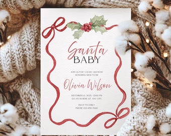 May include: A baby shower invitation with the words "Santa Baby" in elegant script. The invitation features a red ribbon border with holly and berry accents. The text includes the name "Olivia Wilson", date, time, and RSVP information.