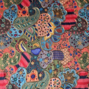 May include: A vibrant textile with a patchwork design. The fabric showcases paisley and floral patterns in blue, green, red, and orange, edged with gold trim. The overall design is intricate and detailed, with a rich, textured appearance.
