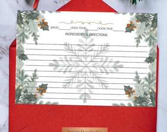 May include: A recipe card with a snowflake design, nestled in a red envelope. The card features lines for ingredients and directions, with decorative winter foliage. The words "Instant Download to Print" are visible.