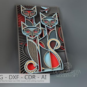 May include: A laser cut design featuring three stylised cats in a geometric pattern. The cats are layered and have a red, blue and gold colour scheme. The design is framed with a black background and a red and black striped pattern.